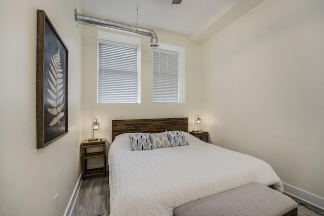 bedroom with ceiling fan and dark hardwood / wood-style floors