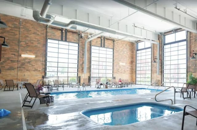 view of pool with an indoor hot tub