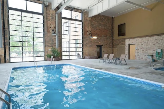 view of swimming pool featuring a lanai and a patio