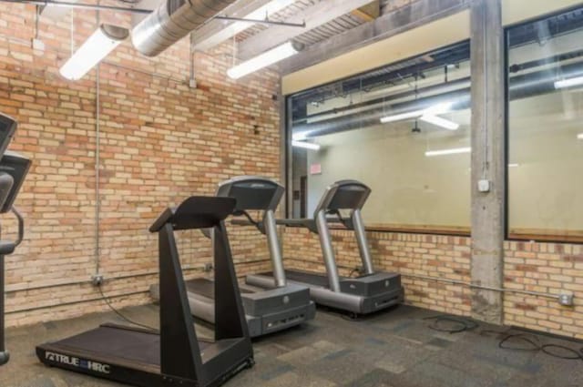 exercise area featuring brick wall