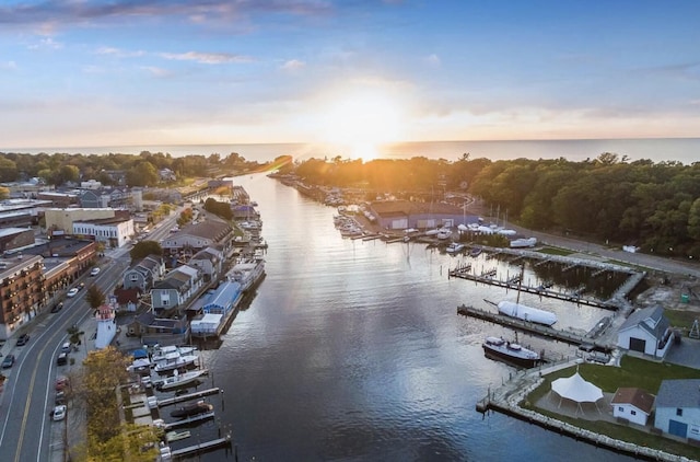 aerial view at dusk featuring a water view