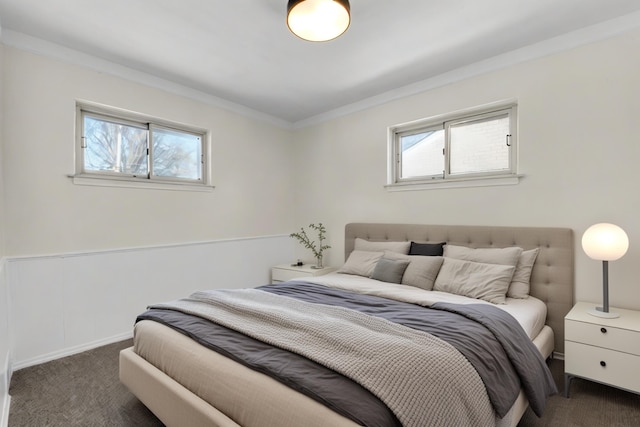 bedroom featuring ornamental molding and dark colored carpet