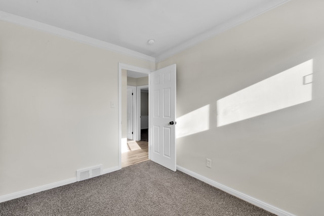 carpeted empty room featuring ornamental molding