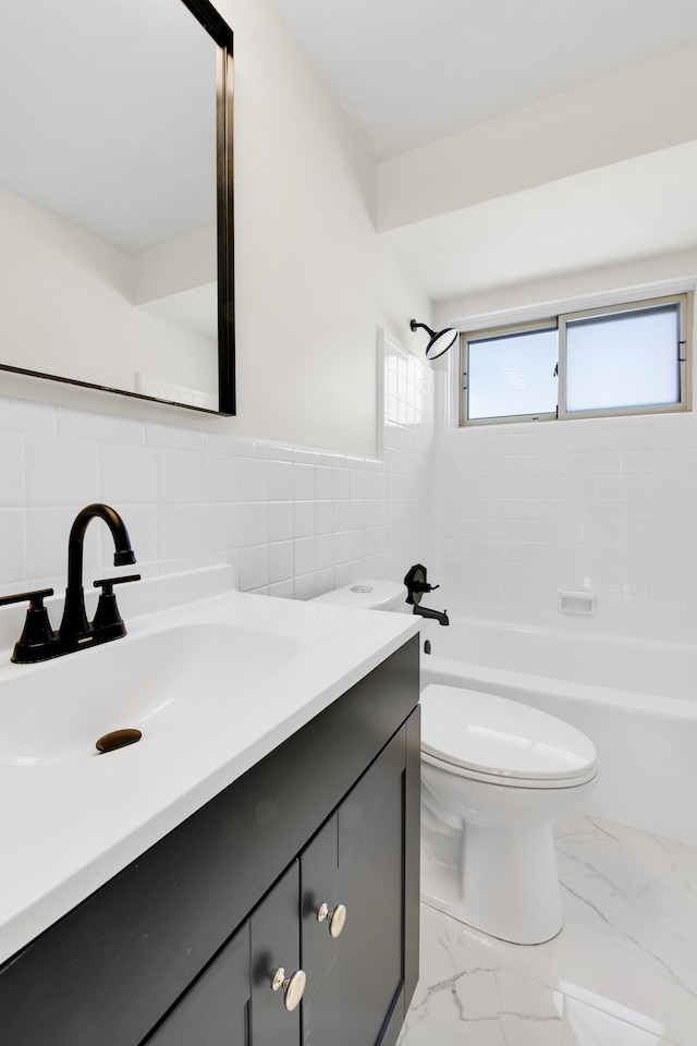 full bathroom featuring tiled shower / bath, vanity, toilet, and tile walls