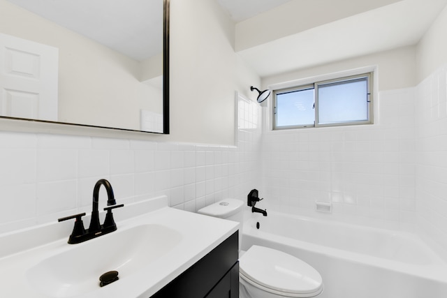 full bathroom featuring tiled shower / bath combo, vanity, tile walls, and toilet