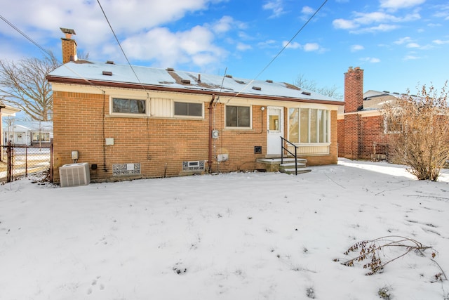 snow covered property featuring cooling unit