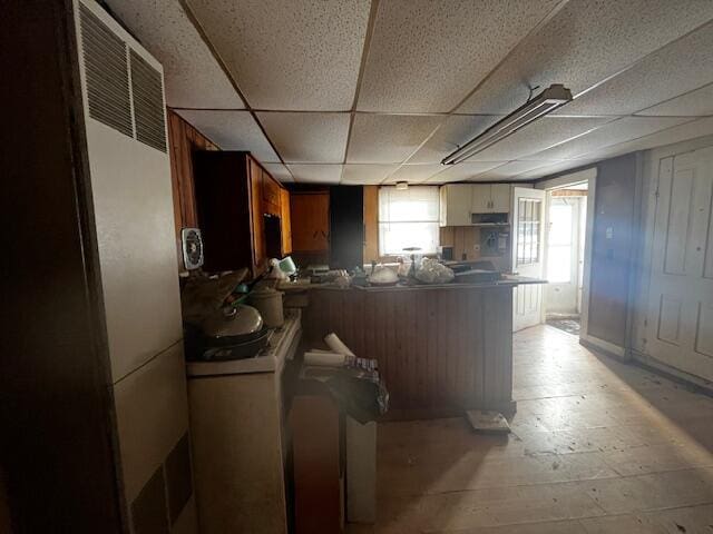 kitchen with a paneled ceiling and kitchen peninsula