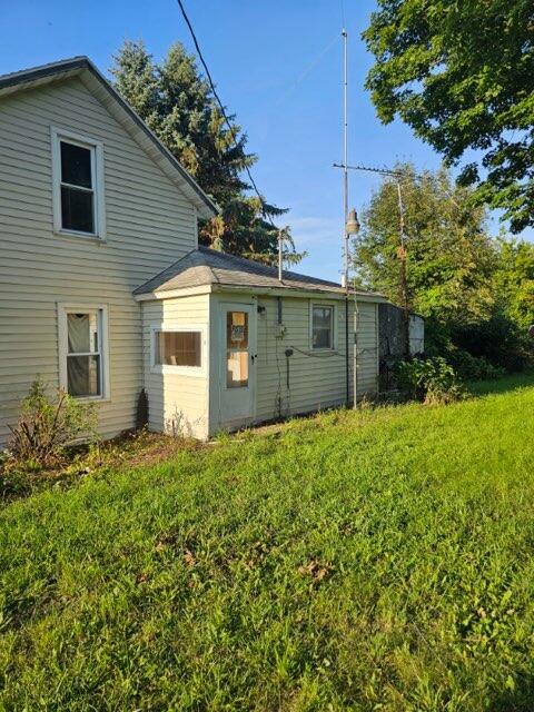 rear view of property featuring a yard