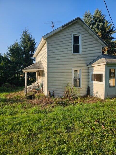 view of property exterior featuring a lawn