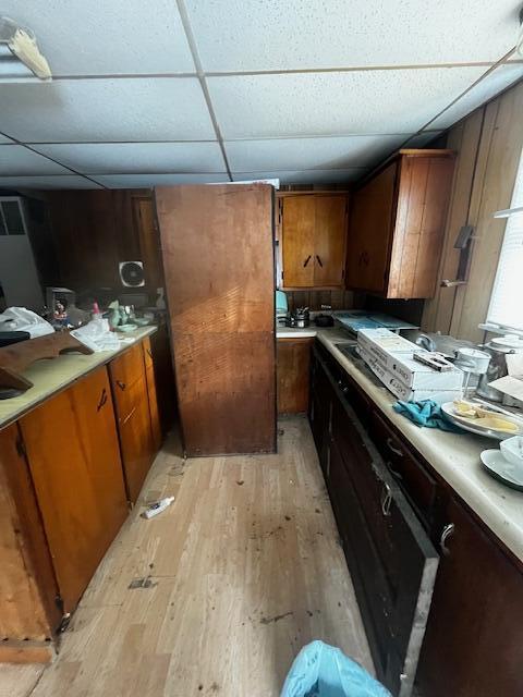 kitchen with a drop ceiling and light hardwood / wood-style floors