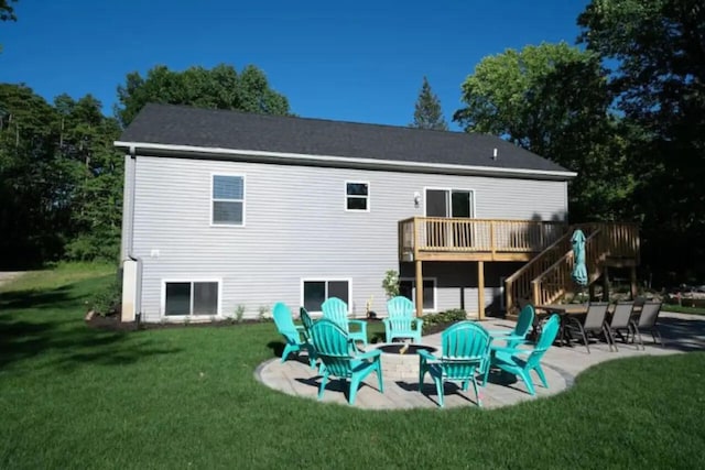 rear view of house featuring a wooden deck, a lawn, a patio area, and an outdoor fire pit