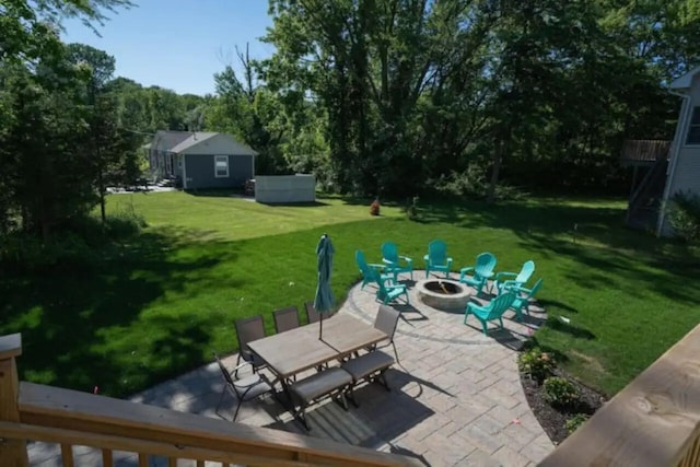 view of patio / terrace featuring an outbuilding and an outdoor fire pit