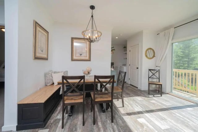 dining area featuring wood-type flooring and a chandelier