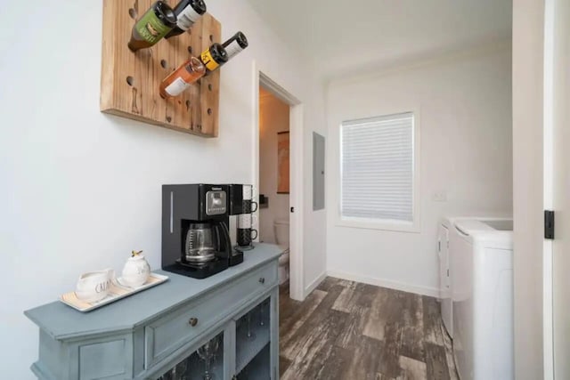 laundry room featuring dark wood-type flooring, electric panel, and washer and clothes dryer