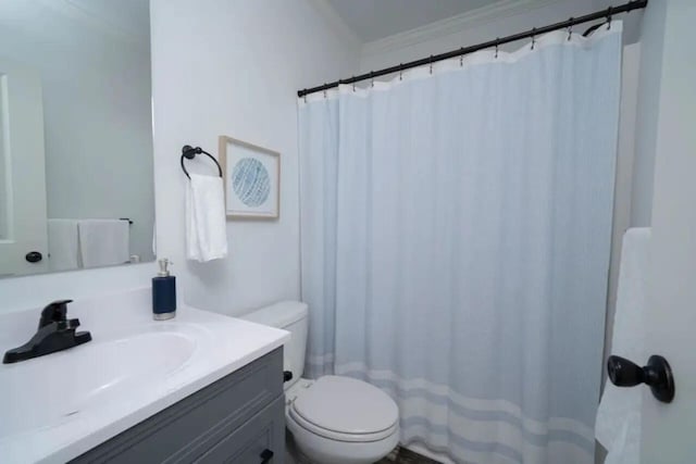 bathroom featuring vanity, ornamental molding, and toilet