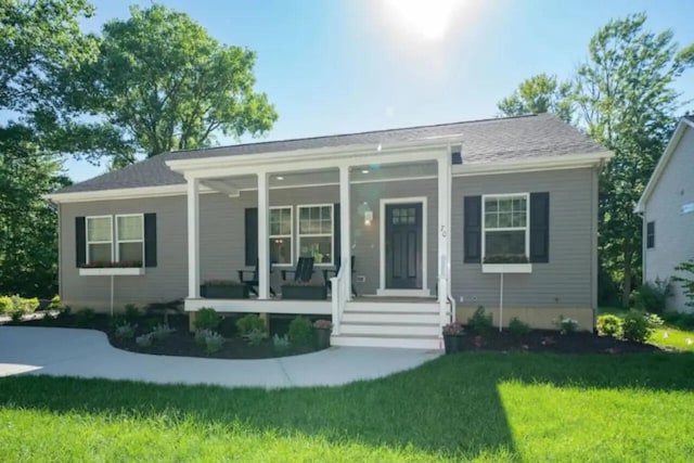 view of front facade with covered porch and a front yard