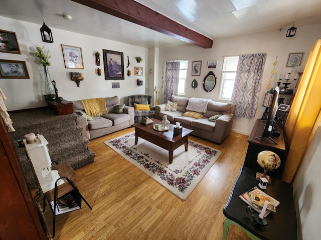 living room featuring beam ceiling and light hardwood / wood-style floors