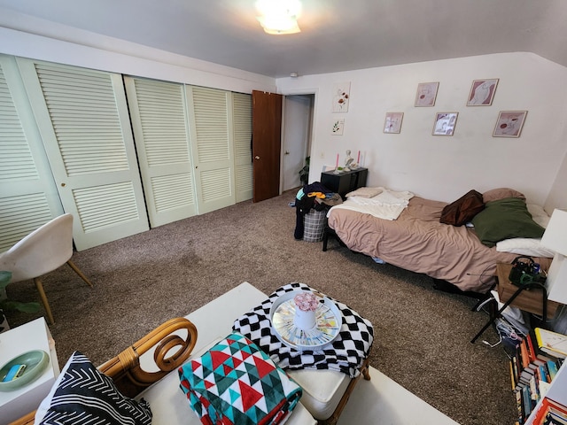 bedroom featuring lofted ceiling, a closet, and carpet