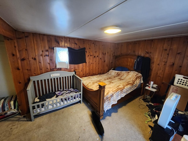 bedroom featuring wooden walls and carpet