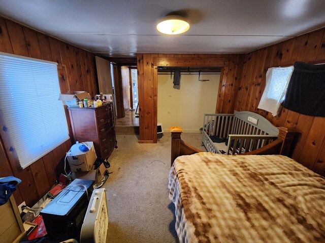 carpeted bedroom featuring wooden walls