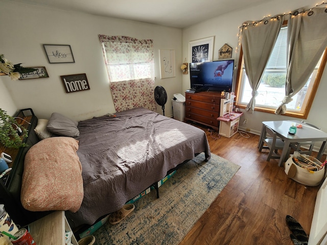 bedroom featuring multiple windows and hardwood / wood-style floors