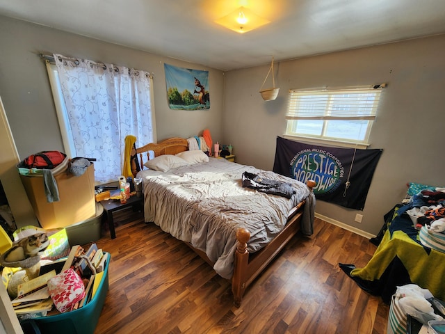 bedroom with dark wood-type flooring