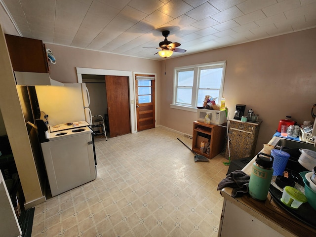 interior space with ceiling fan and a closet