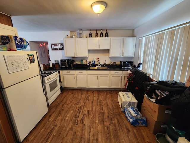 kitchen with sink, white appliances, dark hardwood / wood-style floors, and white cabinets