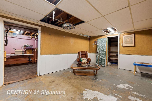 basement featuring a paneled ceiling