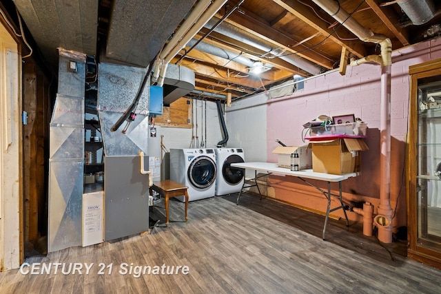 laundry area featuring gas water heater, wood-type flooring, separate washer and dryer, and heating unit