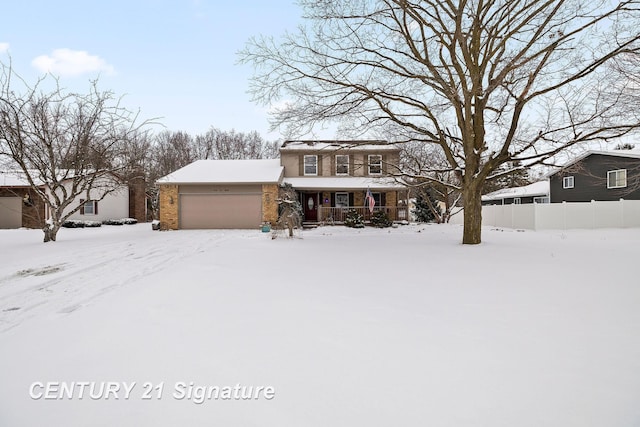 view of property with a garage and a porch