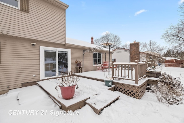 snow covered rear of property with a gazebo and a deck