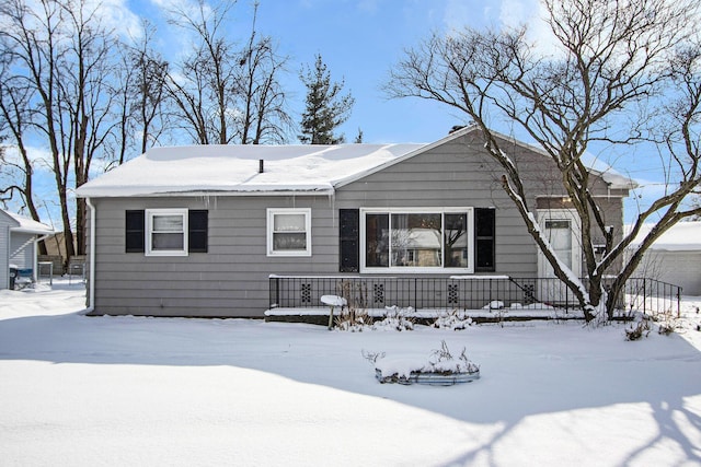 view of snow covered rear of property