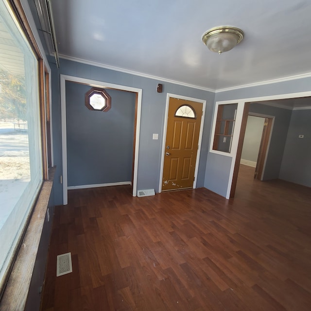 entryway featuring crown molding and dark hardwood / wood-style floors