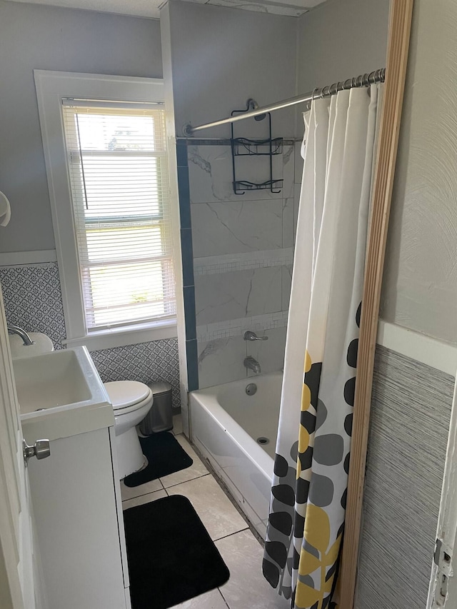 full bathroom featuring shower / bathtub combination with curtain, vanity, tile patterned floors, and toilet