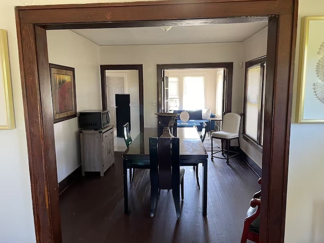 dining area with dark hardwood / wood-style floors