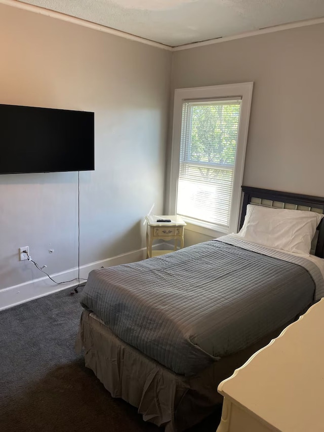 carpeted bedroom featuring crown molding