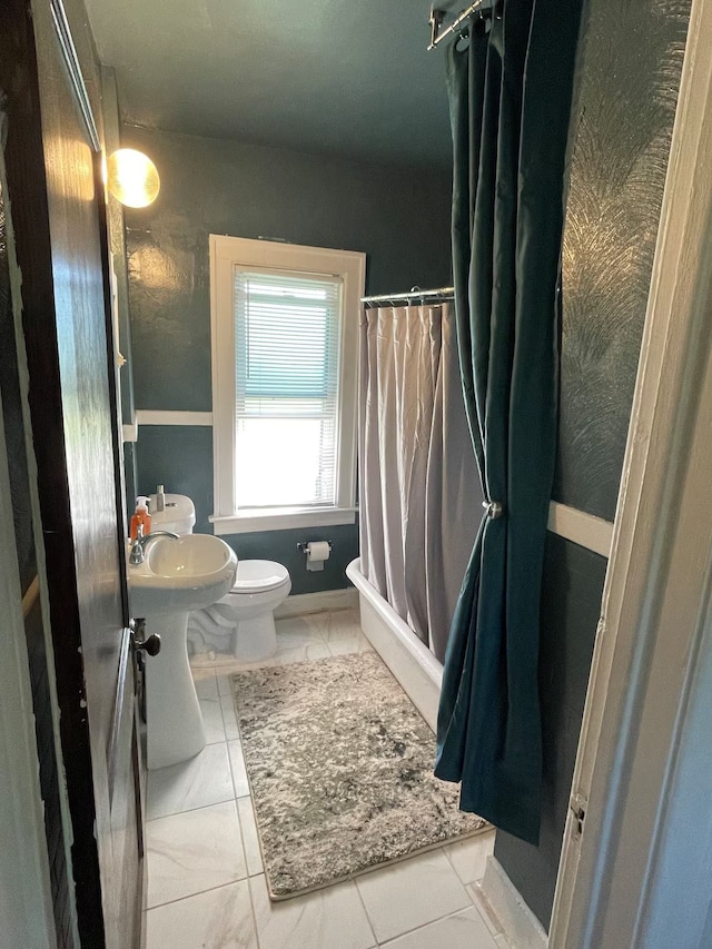 bathroom featuring tile patterned flooring, curtained shower, and toilet