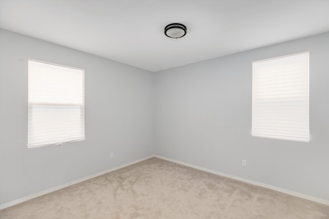 empty room featuring light colored carpet