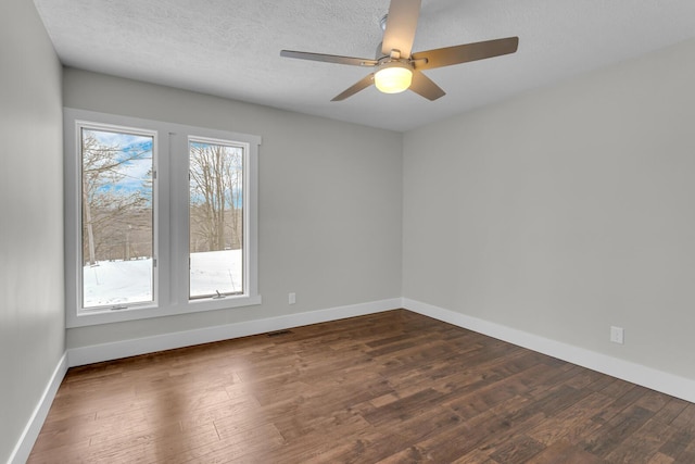 unfurnished room with ceiling fan, dark hardwood / wood-style floors, and a textured ceiling