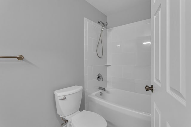 bathroom featuring tiled shower / bath and toilet