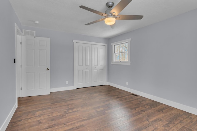 unfurnished bedroom with dark hardwood / wood-style floors and ceiling fan