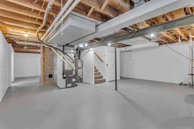 basement featuring heating unit and water heater