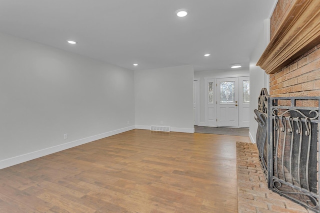 foyer featuring a fireplace and light wood-type flooring