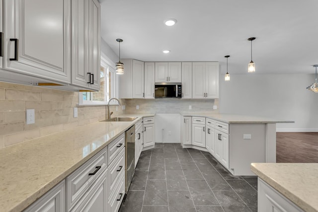 kitchen featuring stainless steel appliances, white cabinetry, and pendant lighting