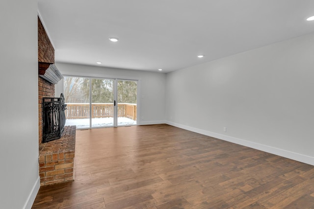 unfurnished living room featuring a fireplace and hardwood / wood-style floors