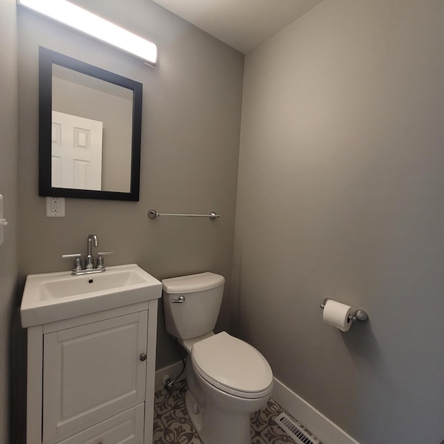 bathroom with vanity, tile patterned floors, and toilet