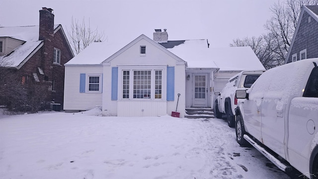 bungalow-style house featuring a chimney