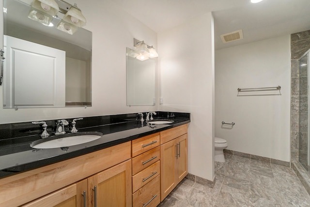 bathroom featuring vanity, toilet, and an enclosed shower