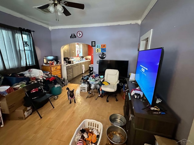 interior space featuring light hardwood / wood-style flooring, ornamental molding, and ceiling fan